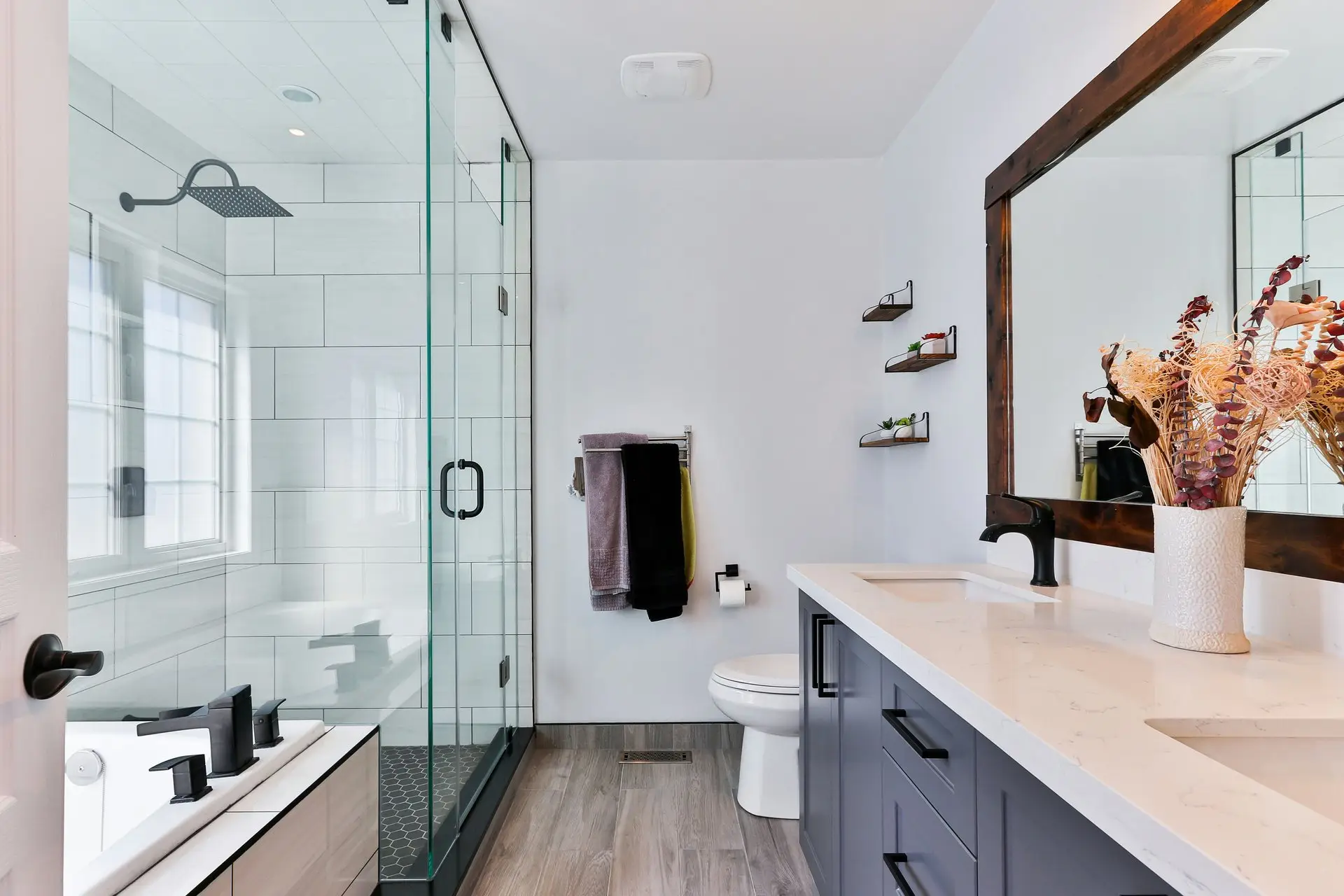 Bathroom remodel with glass walk-in shower, custom vanity, and quartz countertop in San Diego County