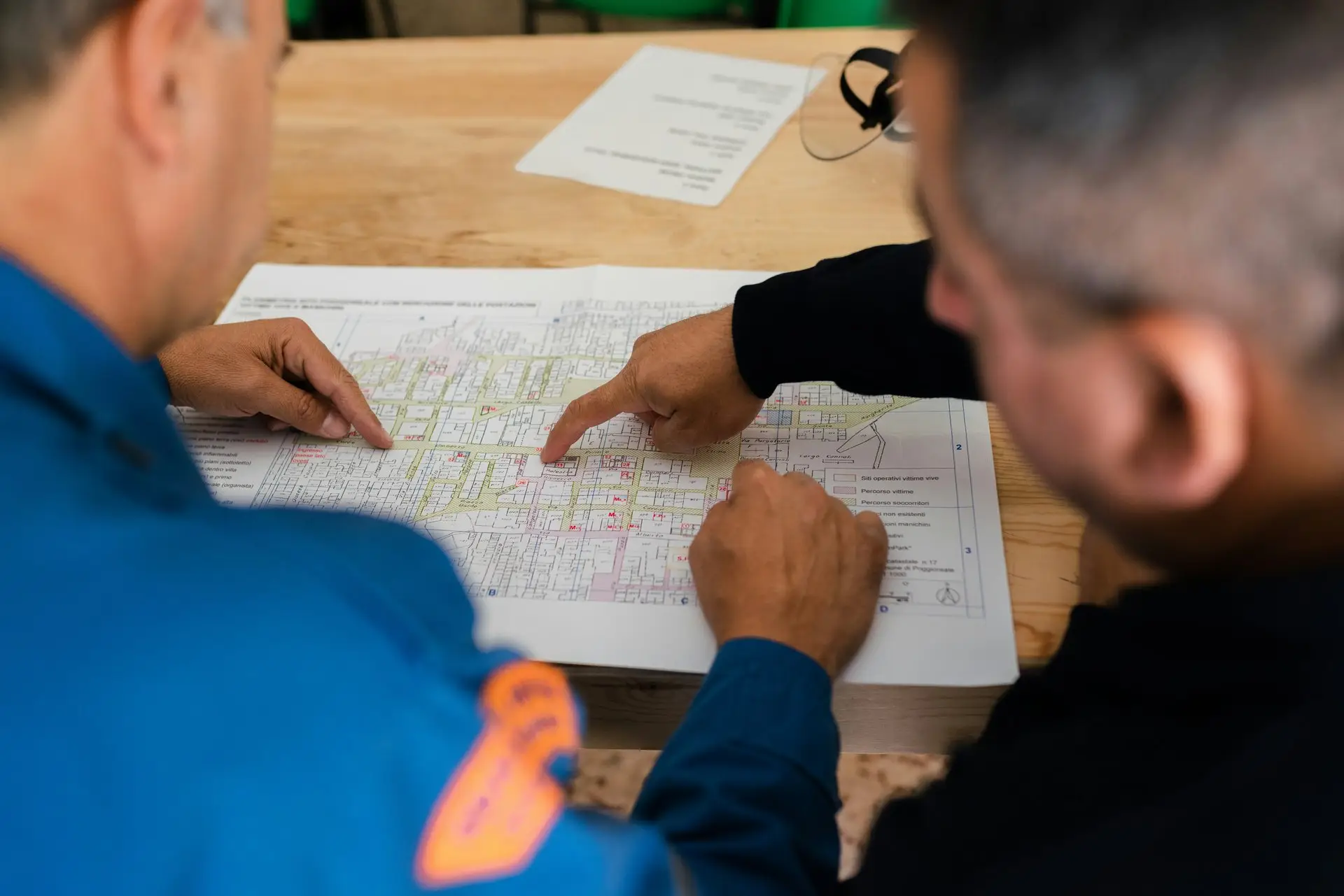 Two contractors reviewing construction blueprints together on a residential project in San Diego